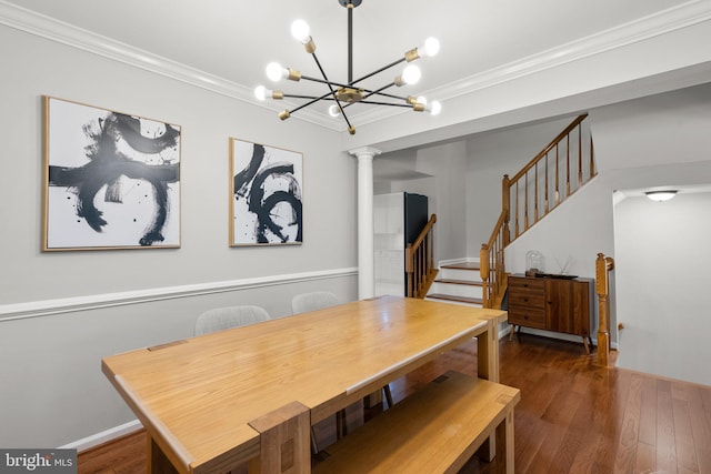 dining space with decorative columns, ornamental molding, stairway, a chandelier, and wood finished floors