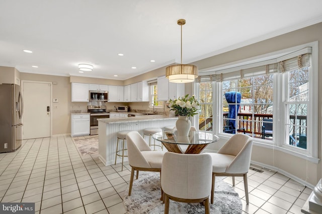 dining space with light tile patterned floors, baseboards, and recessed lighting