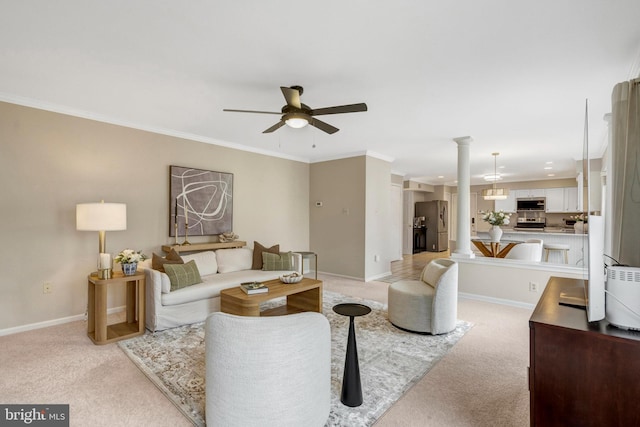 living room with ornamental molding, light colored carpet, and baseboards