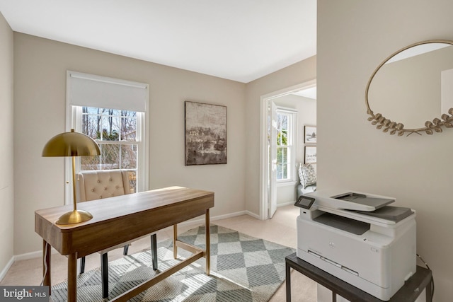 office area featuring light colored carpet and baseboards