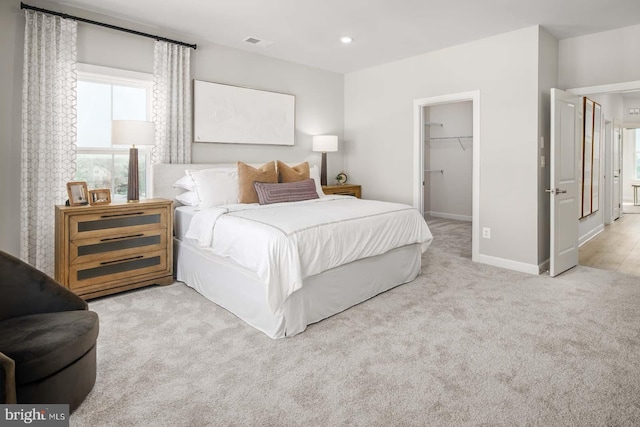 carpeted bedroom with recessed lighting, a closet, visible vents, a spacious closet, and baseboards