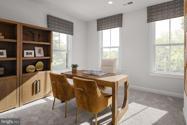 carpeted dining space with visible vents and baseboards