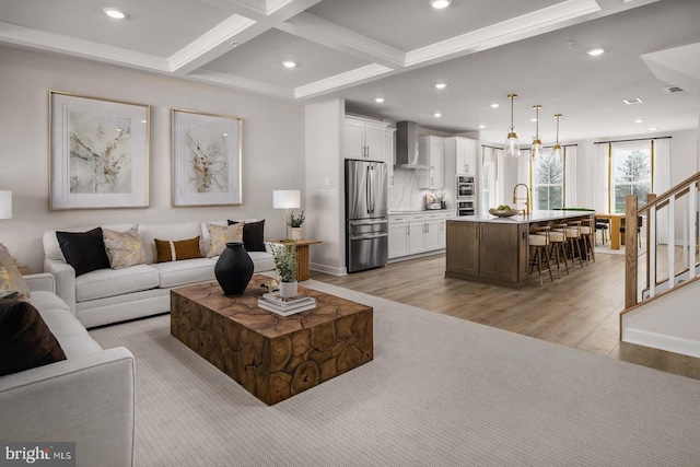 living area with light wood-type flooring, stairway, coffered ceiling, and recessed lighting