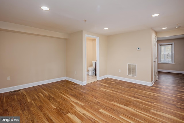 unfurnished room with light wood-style floors, recessed lighting, and visible vents