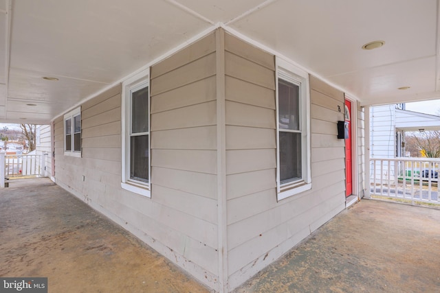 view of side of home featuring covered porch