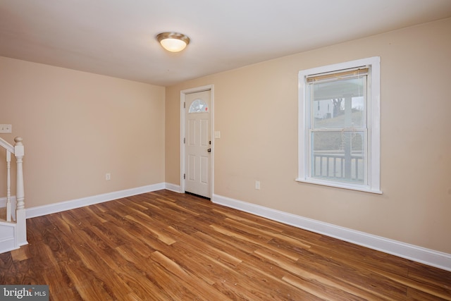 foyer featuring stairway, baseboards, and wood finished floors