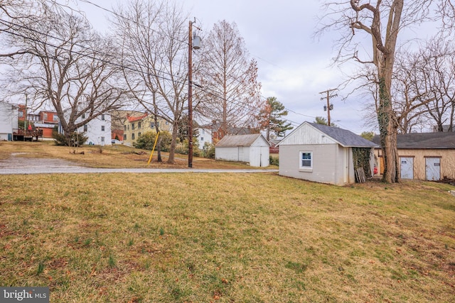 view of yard featuring an outbuilding and a shed