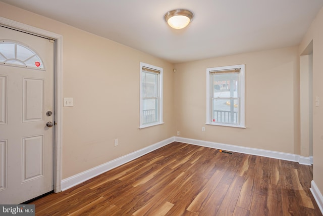 entryway with visible vents, baseboards, and wood finished floors