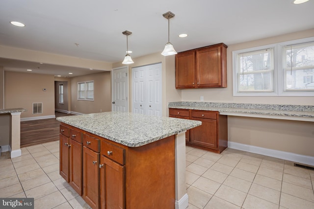 kitchen featuring light tile patterned floors, built in desk, visible vents, and recessed lighting