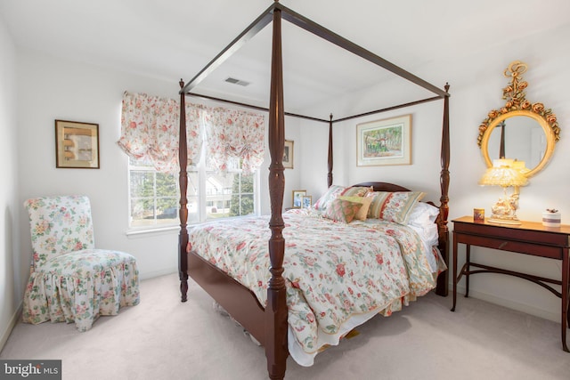 carpeted bedroom featuring visible vents and baseboards