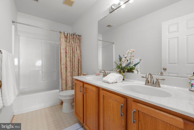 bathroom featuring visible vents, toilet, and a sink