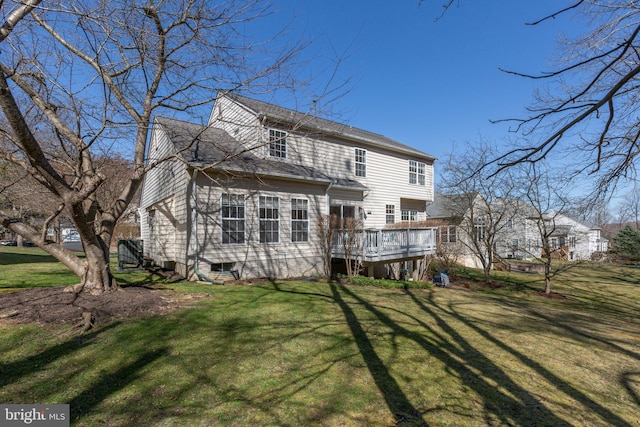 back of house featuring a wooden deck and a lawn