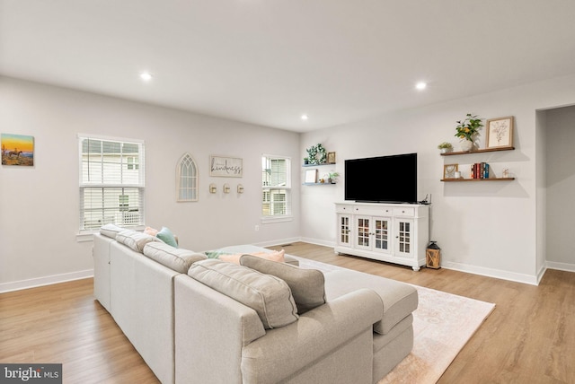 living room featuring recessed lighting, plenty of natural light, light wood-style flooring, and baseboards