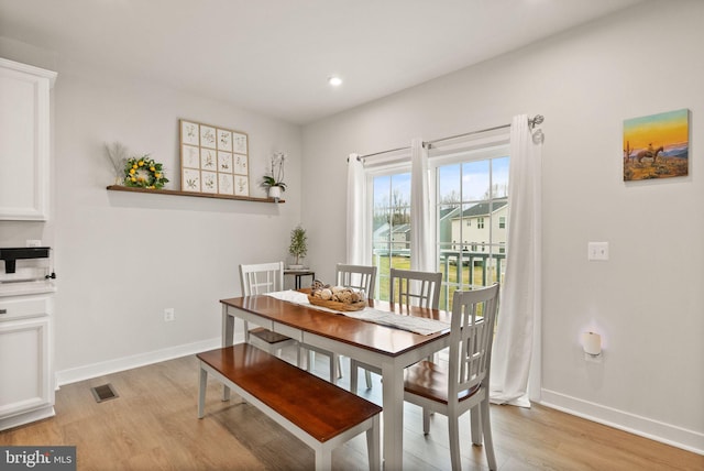 dining space with light wood-style floors, baseboards, visible vents, and recessed lighting