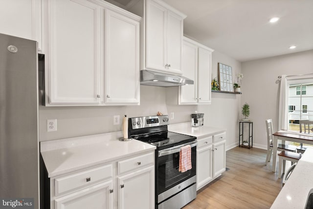 kitchen featuring white cabinets, appliances with stainless steel finishes, light wood-type flooring, under cabinet range hood, and recessed lighting