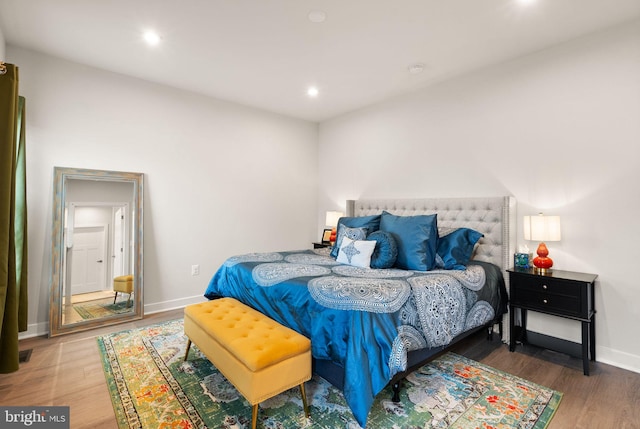 bedroom featuring recessed lighting, wood finished floors, and baseboards