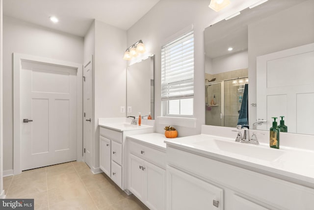 bathroom featuring recessed lighting, two vanities, a sink, tile patterned floors, and a stall shower