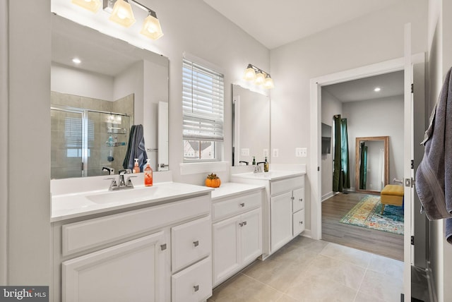 full bath featuring a shower stall, vanity, and tile patterned floors