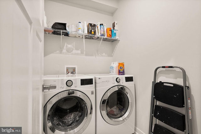 laundry room featuring washing machine and dryer and laundry area