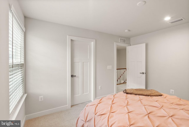 bedroom with carpet flooring, visible vents, and baseboards