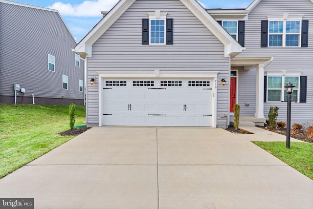 traditional-style home with driveway and a front lawn