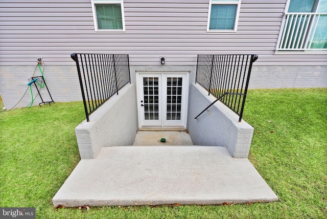 property entrance with a lawn