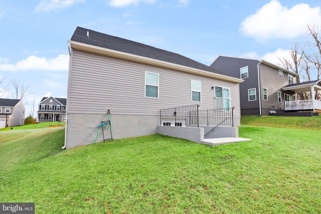 rear view of house with a lawn