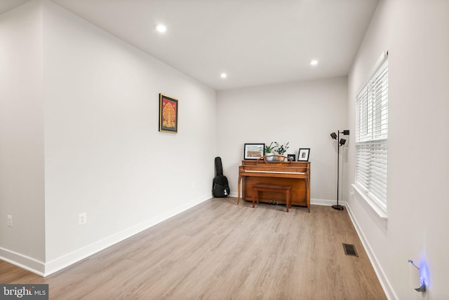 interior space with light wood-style flooring, visible vents, and baseboards