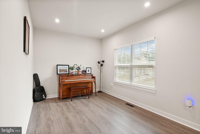 sitting room with recessed lighting, wood finished floors, visible vents, and baseboards