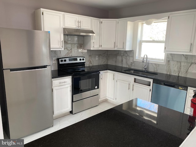 kitchen featuring marble finish floor, stainless steel appliances, white cabinetry, a sink, and under cabinet range hood