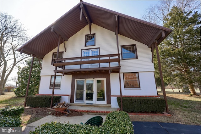 rear view of property featuring a balcony