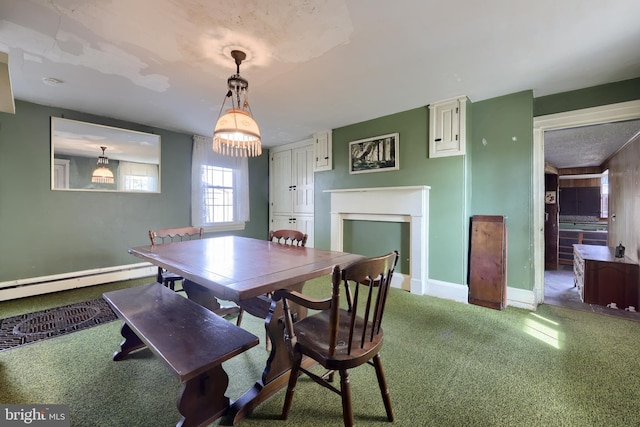 carpeted dining room with a fireplace, baseboards, and baseboard heating