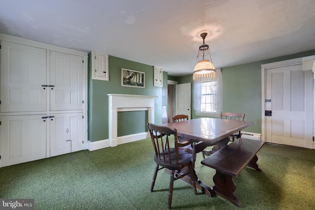 dining area with carpet, a fireplace, a baseboard radiator, and baseboards