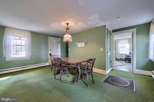 dining room with carpet flooring, baseboards, a healthy amount of sunlight, and baseboard heating