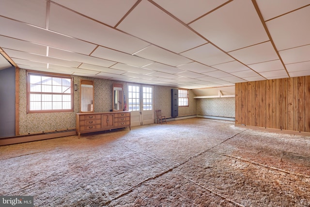 interior space with carpet flooring, baseboard heating, and wallpapered walls