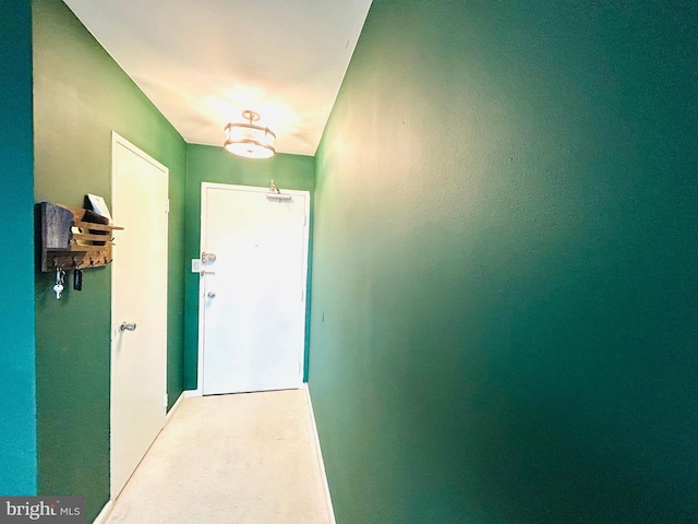 doorway to outside featuring light colored carpet