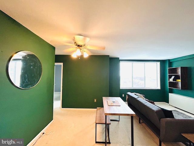 office area with carpet floors, ceiling fan, and baseboards