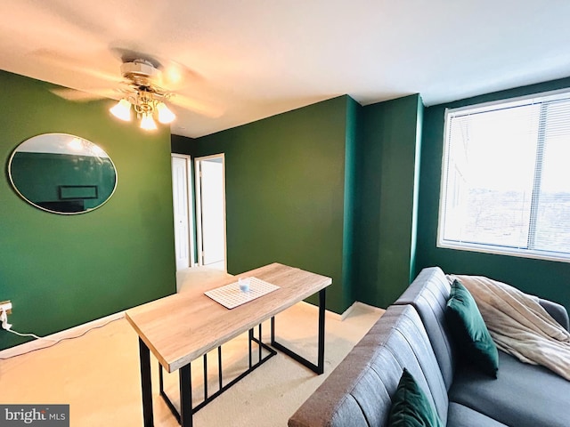 home office with carpet floors, baseboards, and a ceiling fan