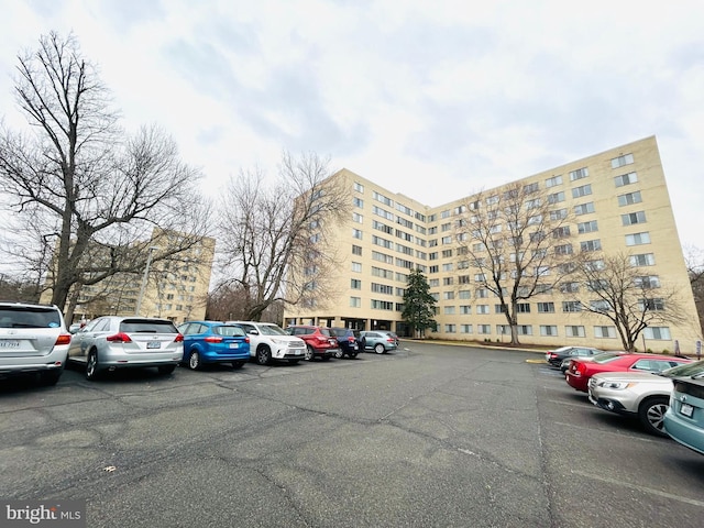 view of building exterior featuring uncovered parking