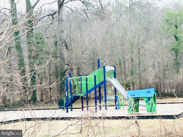 community jungle gym with a wooded view