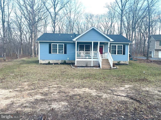 view of front of house with a front lawn, covered porch, roof with shingles, and crawl space