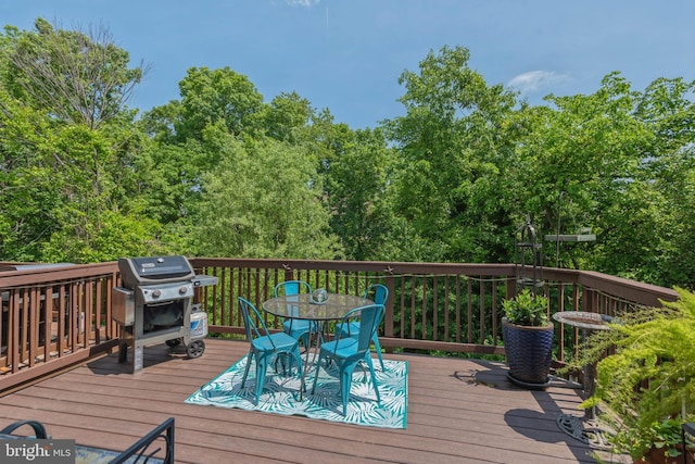 deck featuring outdoor dining area and area for grilling