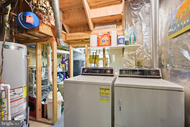 washroom featuring laundry area, water heater, and independent washer and dryer