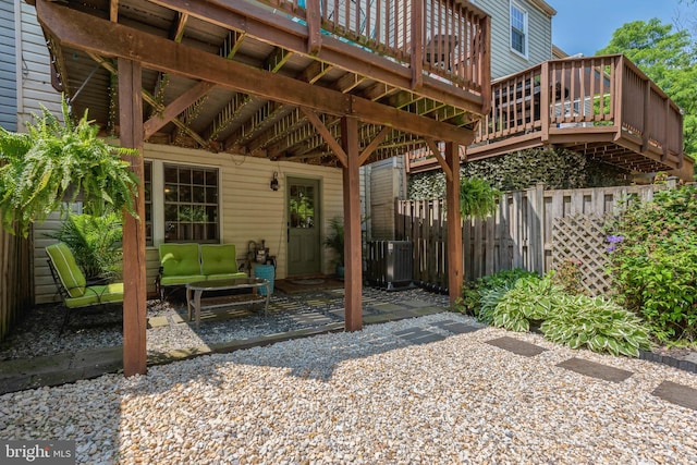 view of patio featuring fence, a deck, cooling unit, and an outdoor living space