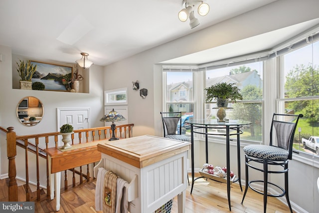 dining area with plenty of natural light and light wood-style floors