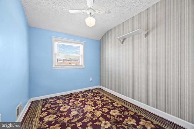 unfurnished room with visible vents, baseboards, a textured ceiling, and carpet flooring