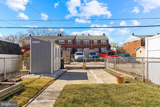 exterior space with an outbuilding, a storage unit, a fenced backyard, and a vegetable garden