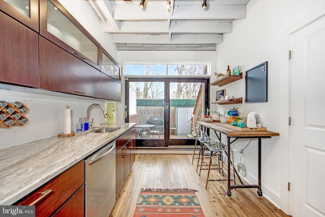 kitchen with glass insert cabinets, dishwasher, a sink, light wood finished floors, and beam ceiling