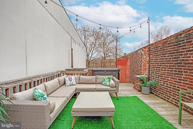 view of patio with a jacuzzi, an outdoor living space, and a deck