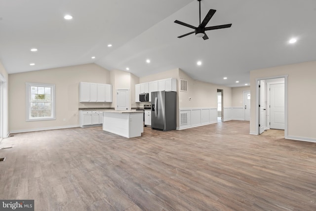 unfurnished living room featuring recessed lighting, visible vents, a ceiling fan, vaulted ceiling, and light wood-type flooring